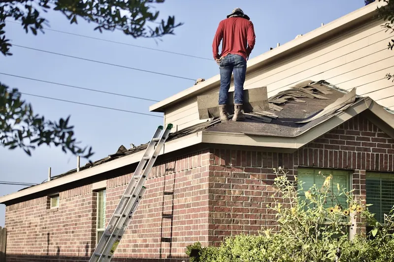Professional roofer working on a residential roof in Mill River